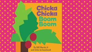 The cover of Chica Chica Boom Boom showing a paper cutout palm tree on a yellow background. The cover is featured on a pink wallpaper with a yellow dot pattern.