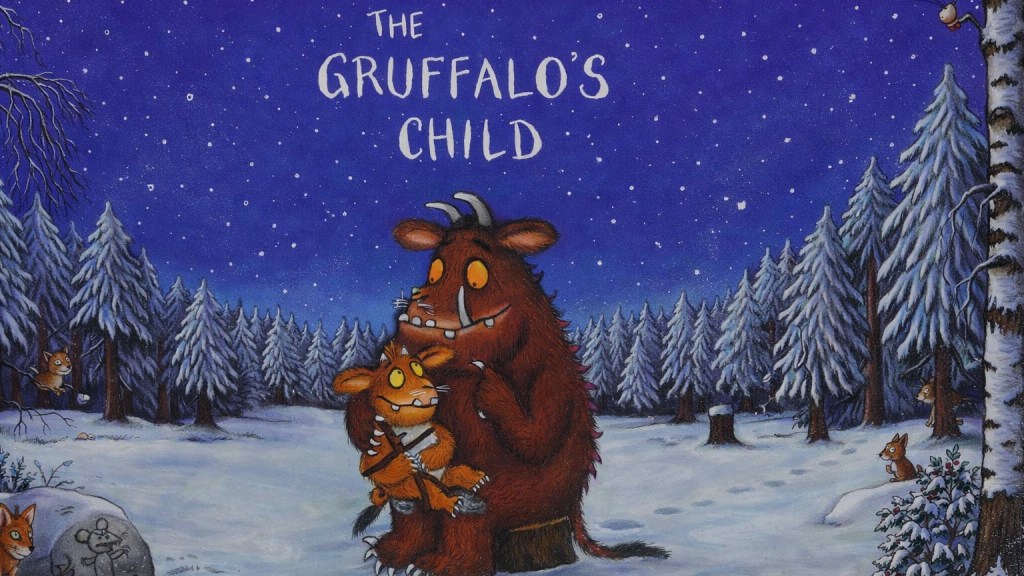 The gruffalo's child cover showing the little gruffalo sitting on the gruffalo's lap against a starry winter scene of snow-covered spruce trees.